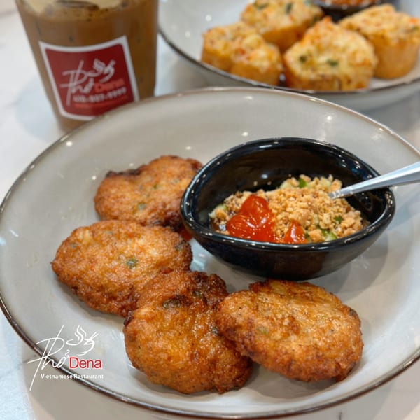 Golden-brown Vietnamese shrimp cakes with a dipping sauce, iced coffee, and savory muffins.