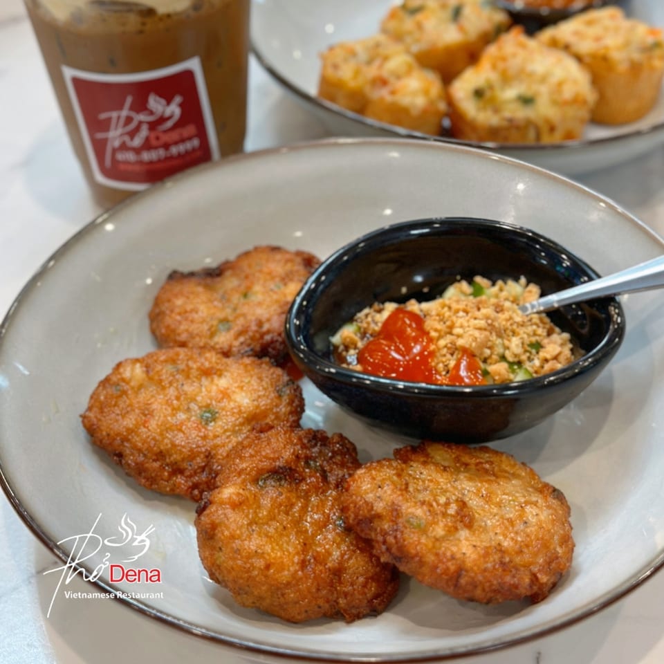 Golden-brown Vietnamese shrimp cakes with a dipping sauce, iced coffee, and savory muffins.